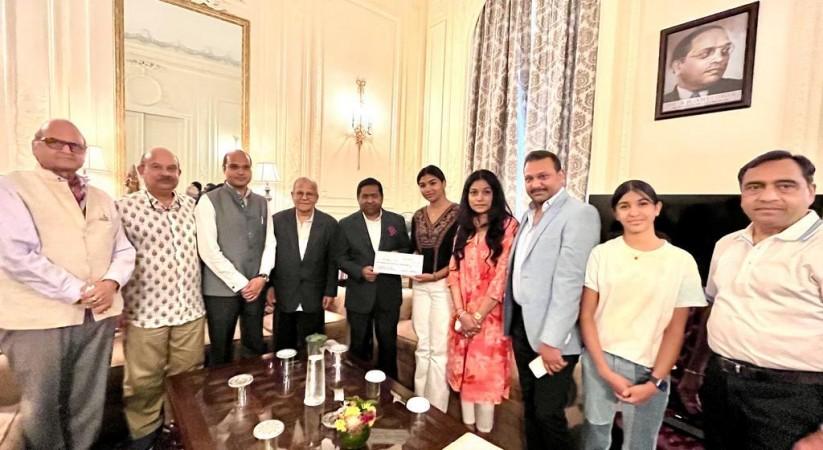 Tanishka Dhariwal presenting $10,000 to Randhir Jaiswal, Consul General of India, NY Tanishka Dhariwal presenting $10,000 to Randhir Jaiswal, Consul General of India, NY