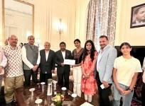 Tanishka Dhariwal presenting $10,000 to Randhir Jaiswal, Consul General of India, NY