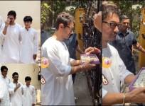 Aamir Khan poses with sons Junaid, Azad at his residence; distributes sweets to paps