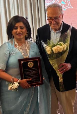 Senate majority leader Chuck Schumer poses with Dr Rekha Bhandari at the AIA event. Senate majority leader Chuck Schumer poses with Dr Rekha Bhandari at the AIA event.