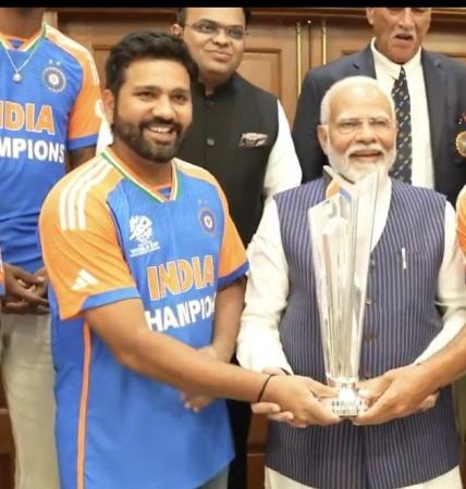PM Narendra Modi beams with joy as he holds WC trophy with captain Rohit Sharma; poses with team India at his residence [Pics]