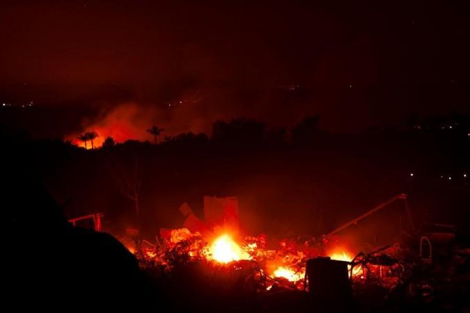 Wildfires rage across US; prompt evacuations, highway shutdown