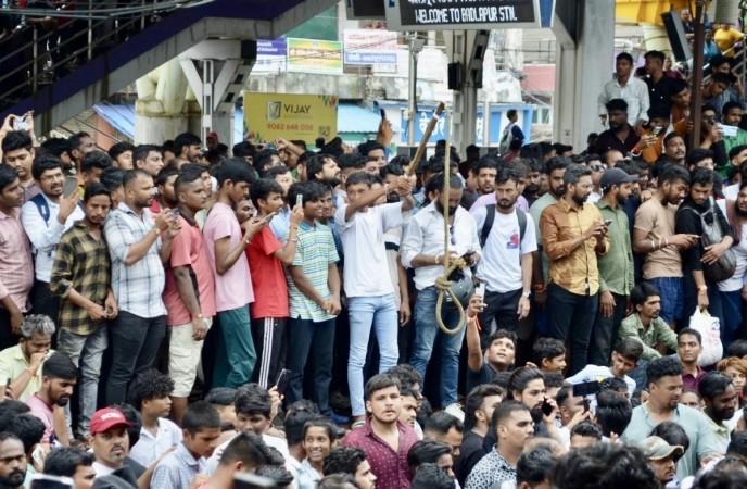 A large group of people gather to stage a massive protest at the Badlapur Railway Station against the alleged sexual assault incident with two girl children at a school A large group of people gather to stage a massive protest at the Badlapur Railway Station against the alleged sexual assault incident with two girl children at a school