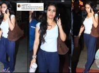 Nysa Devgn in casuals walking outside the airport. She is talking on her phone. Fans noticed that she is wearing headphones and commented the same.