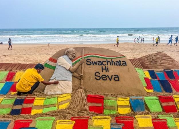 Sand artist Sudarsan Pattnaik creates a sand sculpture with the message 'Swachhata Hi Seva'