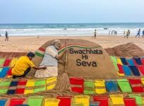 Sand artist Sudarsan Pattnaik creates a sand sculpture with the message 'Swachhata Hi Seva'