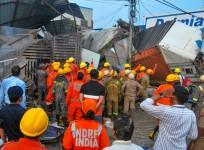 NDRF and Police personnel conduct a rescue operation after a 3-storey building collapsed