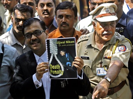 Special Prosecuter Ujjwal Nikam holds up a document, with a cover showing Mohammad Ajmal Kasab, at Arthur Road Jail, where Kasab's trial was held, in Mumbai May 6, 2010
