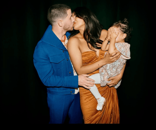 Priyanka and Nick with their daughter Malti at the Jonas Brothers 'The Tour' concert in London. Priyanka-Nick-Malti