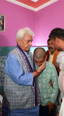 J&K Lieutenant Governor Manoj Sinha consoling family members of police constable who lost his life in the line of duty during Safiyan encounter LG Manoj Sinha