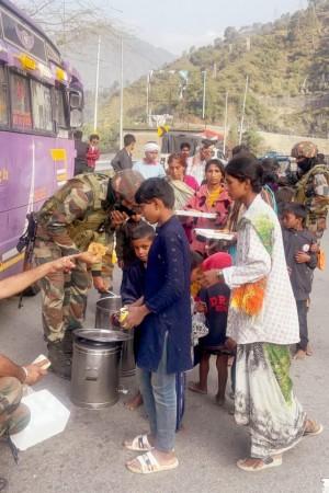 Soldiers of the Indian Army providing food to the passengers stranded at Banihal due to closure of Jammu-Srinagar National Highway Indian Army