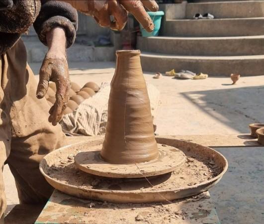 A Kashmiri potter delicately shapes a clay vessel on a traditional wheel in Ishber Nishat, Srinagar reviving the age-old art of glazed pottery, one handcrafted piece at a time. From Commerce Graduate to Cultural Custodian, Kashmiri Artisan Restores Traditional Glazed Pottery.