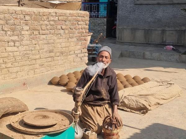 The foundation of a craft revival: Umar Kumar's father at work. From Commerce Graduate to Cultural Custodian, Kashmiri Artisan Restores Traditional Glazed Pottery.