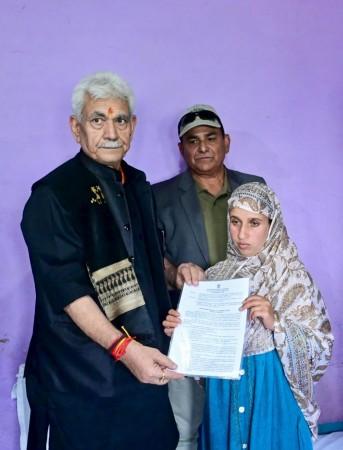 Lieutenant Governor of J&K Manoj Sinha handing over a job letter to Gulnaz Akhter, wife of Adil Shah. Manoj Sinha