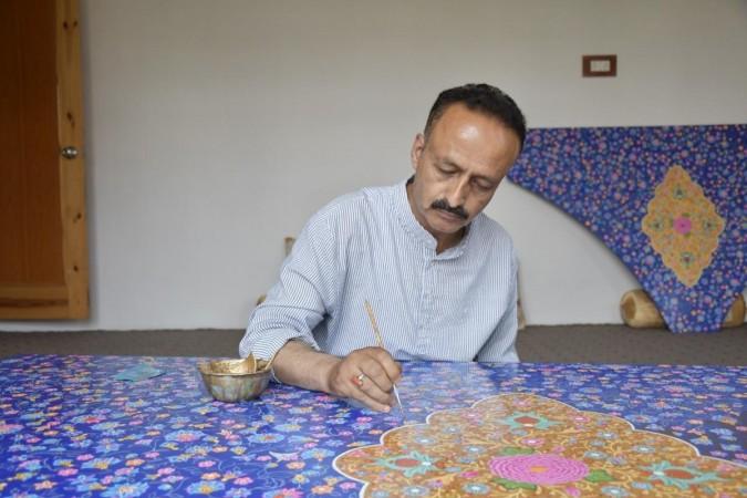 Maqbool Jan practices the age-old naqashi on a handcrafted piece. Photo/Midhat. Paper Mache.