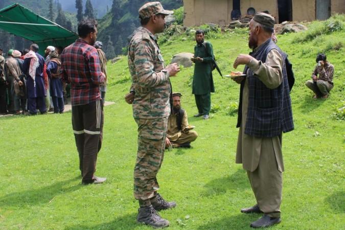 An officer of the Indian Army interacting with an elderly Gujjar at village Kesri Hill in border district of Rajouri Gujjar-Bakerwals