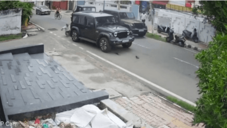 A screenshot of the video of Jammu road rage horror. In the video it is seen that the speeding Thar first collided with the scooty from the opposite direction, resulting which the victim fell. Accident