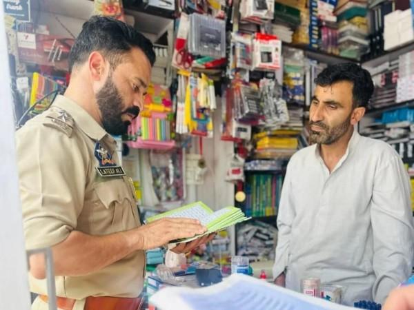 A police officer inspects a bookshop following the government ban on 25 radicalizing books. Cops