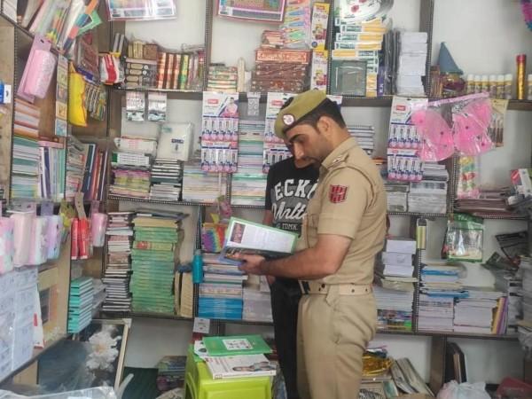 A cop inspecting a bookshop following the government ban on 25 radicalizing books. cops