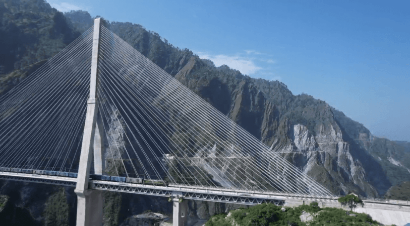 First freight train crossing a bridge before reaching Anantnag train