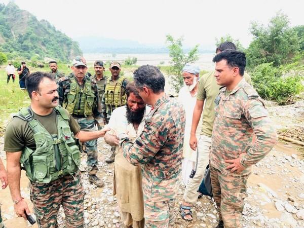 Soldiers of the Indian Army consoling member of a Gujjar family who lost five members in cloudburst Kathua floods