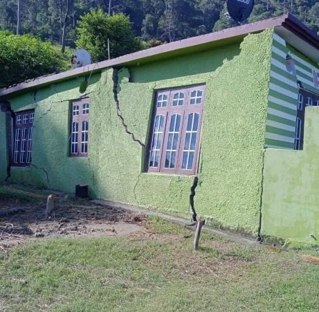 A residential building developed cracks due to sinking of land Sinking
