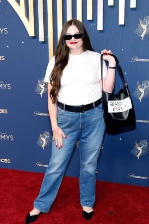 Actor Meg Stalter made a bold style statement as she carried a black leather bag with white tape that reads, Actor Meg Stalter made a bold style statement as she carried a black leather bag with white tape that reads,
