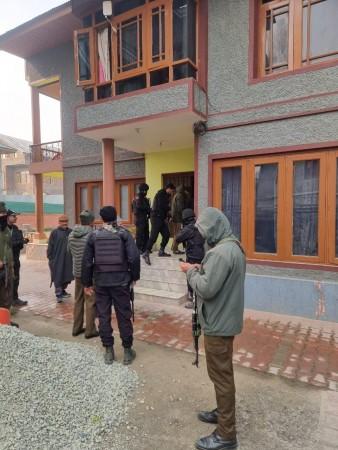 Cops searching a house in Budgam district in connection with crackdown on radical elements in Kashmir J&K Police