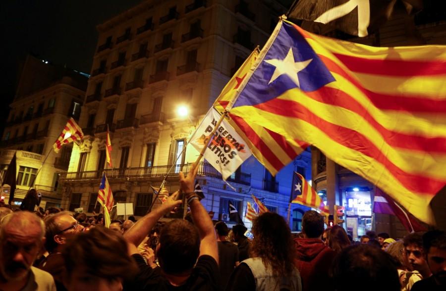Protestors wave Catalan separatist flags following a demonstration on the first anniversary Catalan referendum anniversary,Riot police,Catalonia regional parliament,Barcelona,demonstration,Catalan anniversary