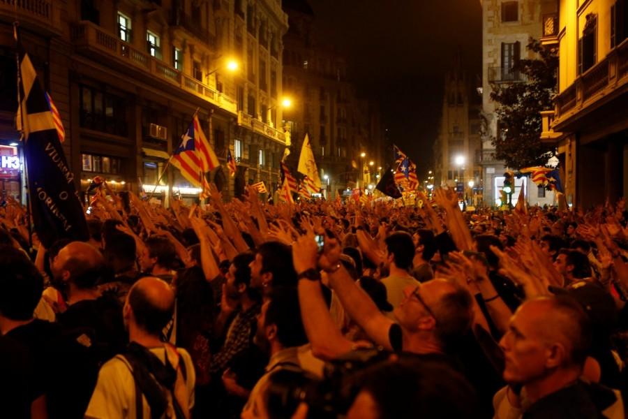 Protestors gesture during a demonstration Catalan referendum anniversary,Riot police,Catalonia regional parliament,Barcelona,demonstration,Catalan anniversary