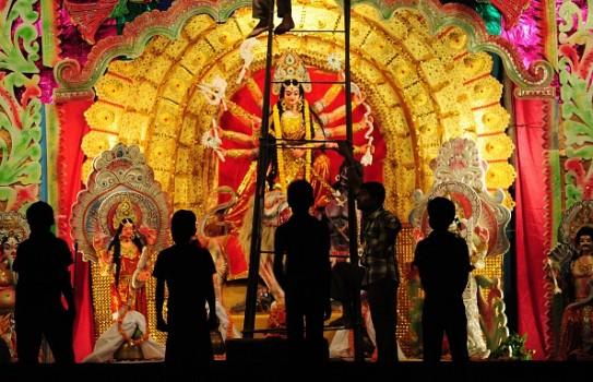 Indian artisans give the final touches to a Durga Puja pandal