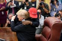 Rapper Kanye West hugs U.S. President Donald Trump