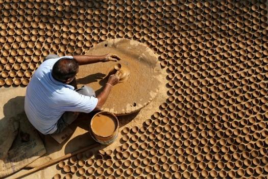 An Indian potter makes diyas (earthen lamps)