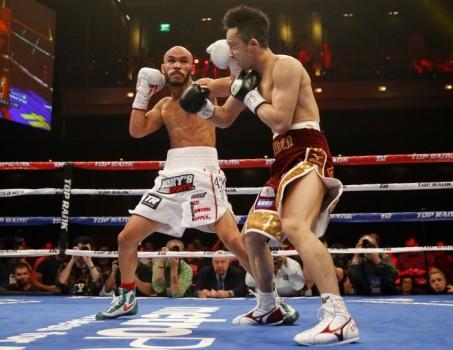 Takahiro Ao of Japan takes a punch from Ray Beltran of Mexico (L) in the second round during their 12-round bout for the vacant World Boxing Organization (WBO) lightweight world championship title in Las Vegas
