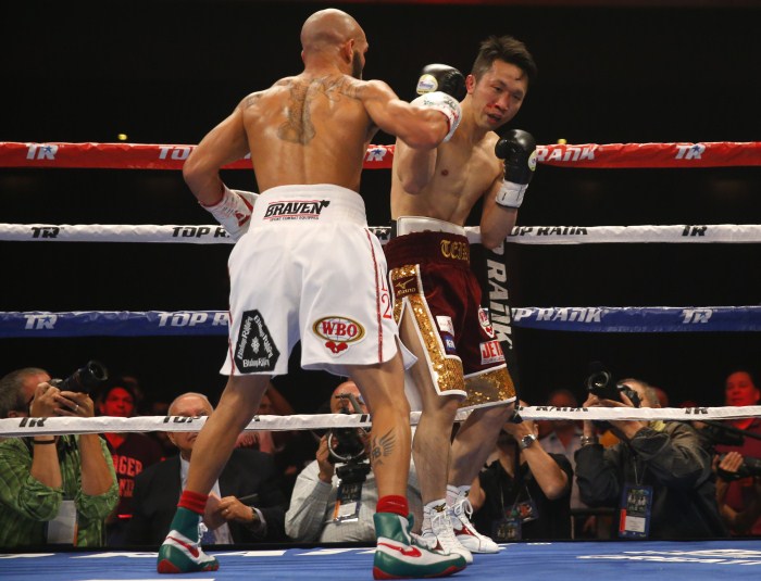 Takahiro Ao of Japan takes a pounding in the second round from Ray Beltran of Mexico before the fight is called during their 12-round bout for the vacant World Boxing Organization (WBO) lightweight world championship title in Las Vegas World Boxing Organization,Lightweight World Boxing Championship 2015,Boxing Championship 2015,World Boxing Championship 2015,Lightweight World Boxing Championship,Boxing Championship