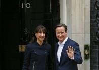 Britain's Prime Minister David Cameron waves as he arrives with his wife Samantha at Number 10 Downing Street in London, Britain