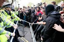 Protesters and police face off at the gates of Downing Street during a protest against the Conservative Party in central London