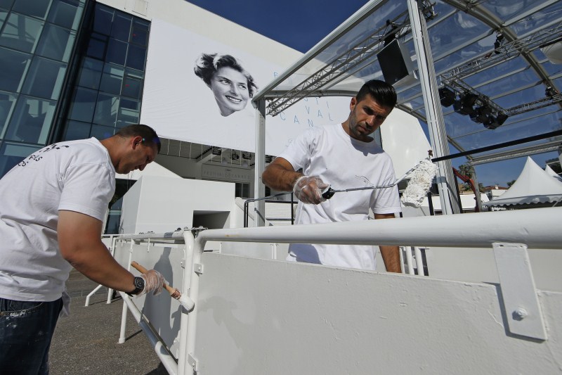 Workers paint the railings outside the Festival Palace during preparations before the start of the 68th Cannes Film Festival in Cannes Gearing Up for Cannes Film Festival 2015,68th Cannes Film Festival 2015,Cannes Film Festival 2015,French Riviera town,Cannes Film Festival pics,Cannes Film Festival images,Cannes Film Festival,2015 Cannes Film Festival,Festival de Cannes 2015,cannes film