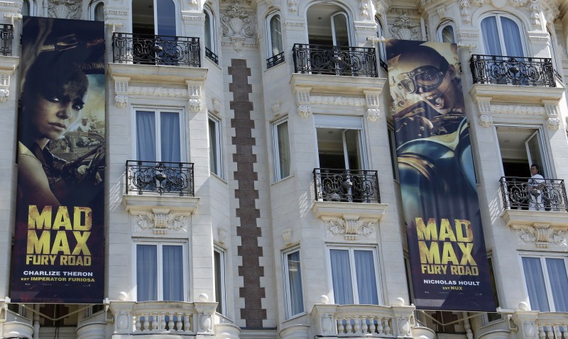 Posters for the film Mad Max: Fury Road actress showing Charlize Theron and actor Nicholas Hoult are displayed outside the Carlton Hotel. Gearing Up for Cannes Film Festival 2015,68th Cannes Film Festival 2015,Cannes Film Festival 2015,French Riviera town,Cannes Film Festival pics,Cannes Film Festival images,Cannes Film Festival,2015 Cannes Film Festival,Festival de Cannes 2015,cannes film