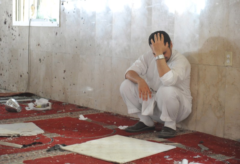 A family member of a slain victim mourns after arriving at the Imam Ali mosque ISIS Suicide Bomber attacks Saudi Shiite Mosque,ISIS Suicide Bomber,Saudi Arabia attack,Al Qudaih,Mosque attack,ISIS suicide bomber attacks,Shiite mosque,Saudi Press Agency,terrorist cell,terrorist attack,terrorist attack on Mosque