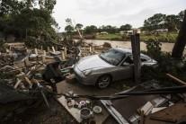 A totaled Porsche rests against the foundation of a home destroyed by the Memorial Day weekend floods in Wimberley, Texas