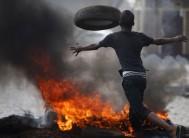 A protester sets up a barricade during a protest against Burundi President Pierre Nkurunziza and his bid for a third term in Bujumbura
