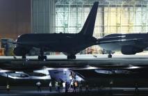 The Solar Impulse 2 (foreground), a solar powered plane, sits on the tarmac after it landed at Nagoya airport in Japan