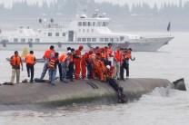 A man is pulled out alive by divers and rescuers after a ship sank at the Jianli section of the Yangtze River, Hubei province, China