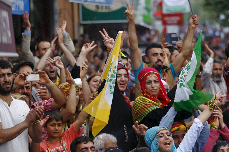 Supporters of pro-Kurdish Peoples' Democratic Party (HDP) flash V-signs during an election rally for Turkey's Turkey Faces a New Political Reality,Turkey New Political Reality,New Political Reality,Tayyip Erdogan,AK Party,Erdogan,Supporters of Turkey's,Turkey,Prime Minister Ahmet Davutoglu,Ahmet Davutoglu