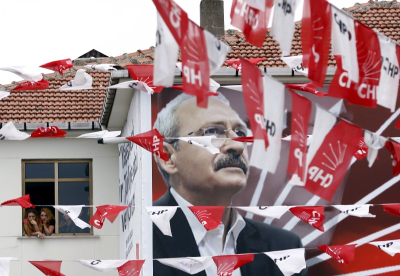 Women standing at a window listen to pro-Kurdish Peoples' Democratic Party (HDP) co-chair Selahattin Demirtas, as a poster of main opposition Republican People's Party (CHP) leader Kemal Kilicdaroglu is seen in the foreground Turkey Faces a New Political Reality,Turkey New Political Reality,New Political Reality,Tayyip Erdogan,AK Party,Erdogan,Supporters of Turkey's,Turkey,Prime Minister Ahmet Davutoglu,Ahmet Davutoglu