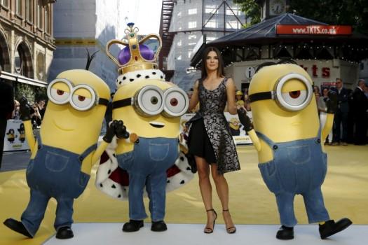 Actress Sandra Bullock poses with characters in costume from the film during the 'Minions' World Premiere at Leicester Square in London