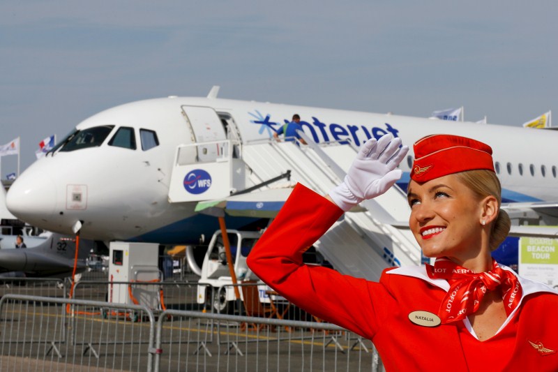 A cabin crew member of Russian carrier Aeroflot poses in front of a Sukhoi Superjet 100 airplane during a photo session at the 51st Paris Air Show at Le Bourget airport near Paris 51st Paris Air Show,51st Paris Air Show at Le Bourget Airport,Le Bourget Airport,Air Show,51st International Paris Air Show,51st Paris Air Show 2015,Air Show 2015,Air Show pics,Paris International Air Show 2015,Paris air show