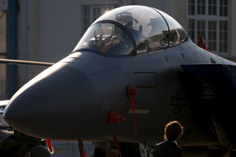 A visitor walks past an aircraft at the static display area in the early morning during the 51st Paris Air Show 51st Paris Air Show,51st Paris Air Show at Le Bourget Airport,Le Bourget Airport,Air Show,51st International Paris Air Show,51st Paris Air Show 2015,Air Show 2015,Air Show pics,Paris International Air Show 2015,Paris air show
