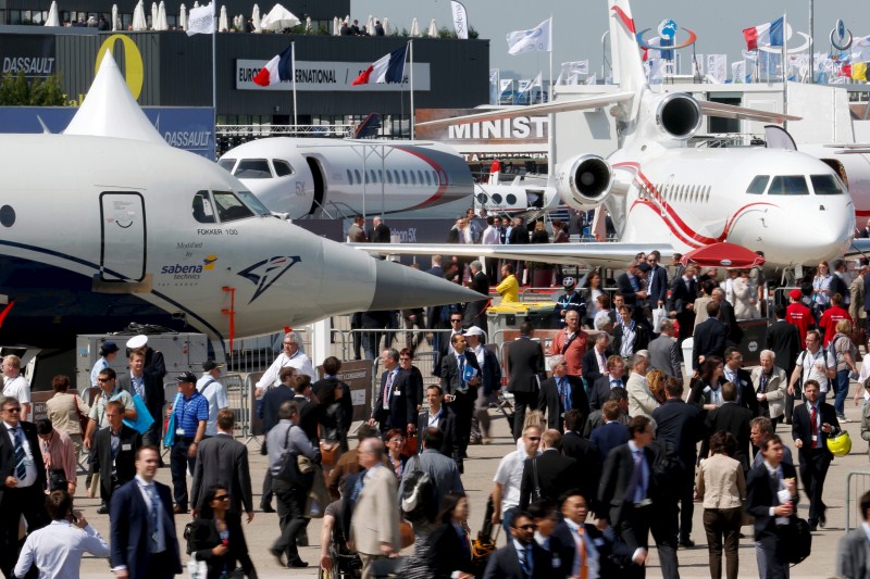 Visitors walk at the static display area during the 51st Paris Air Show at Le Bourget airport near Paris 51st Paris Air Show,51st Paris Air Show at Le Bourget Airport,Le Bourget Airport,Air Show,51st International Paris Air Show,51st Paris Air Show 2015,Air Show 2015,Air Show pics,Paris International Air Show 2015,Paris air show